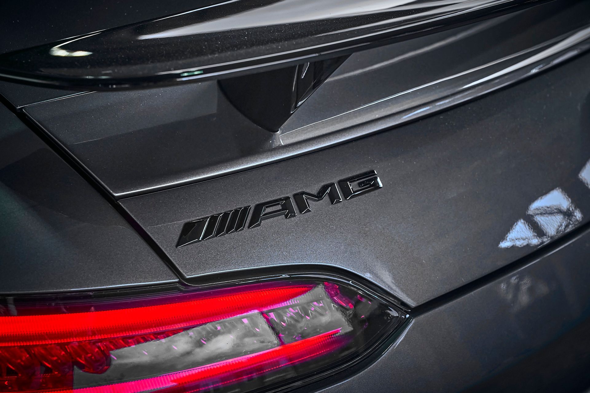 A close up of the rear end of a mercedes amg car.