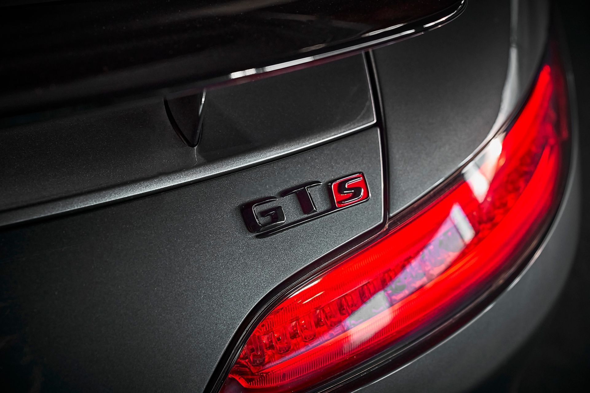 A close up of a car 's tail light with the word gts on it