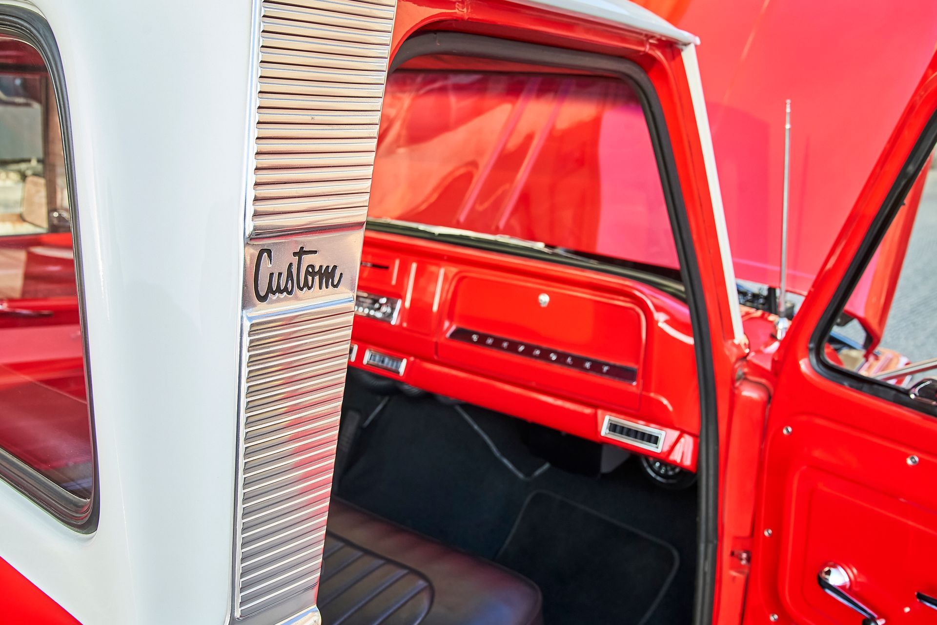 The inside of a red and white truck with the door open.