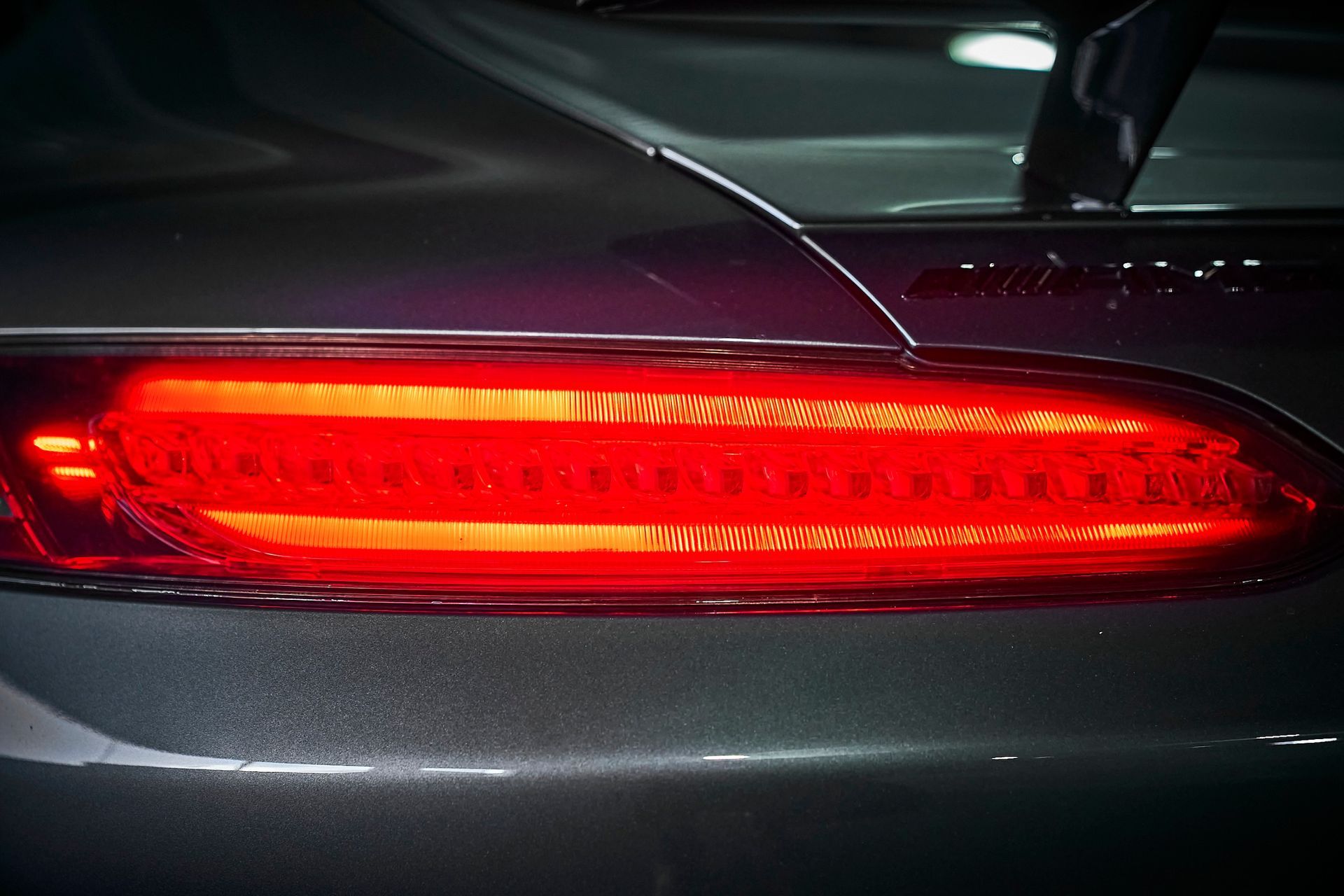 A close up of a car 's tail light that is red