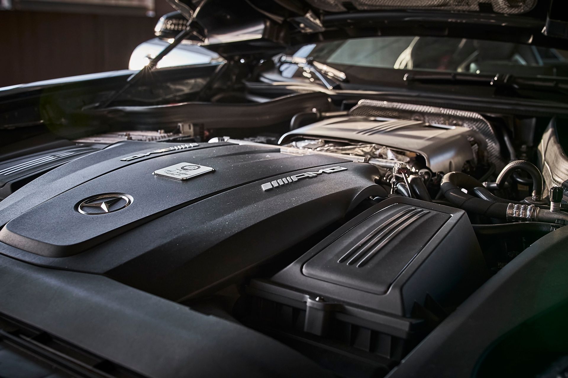 A close up of a car engine with the hood open