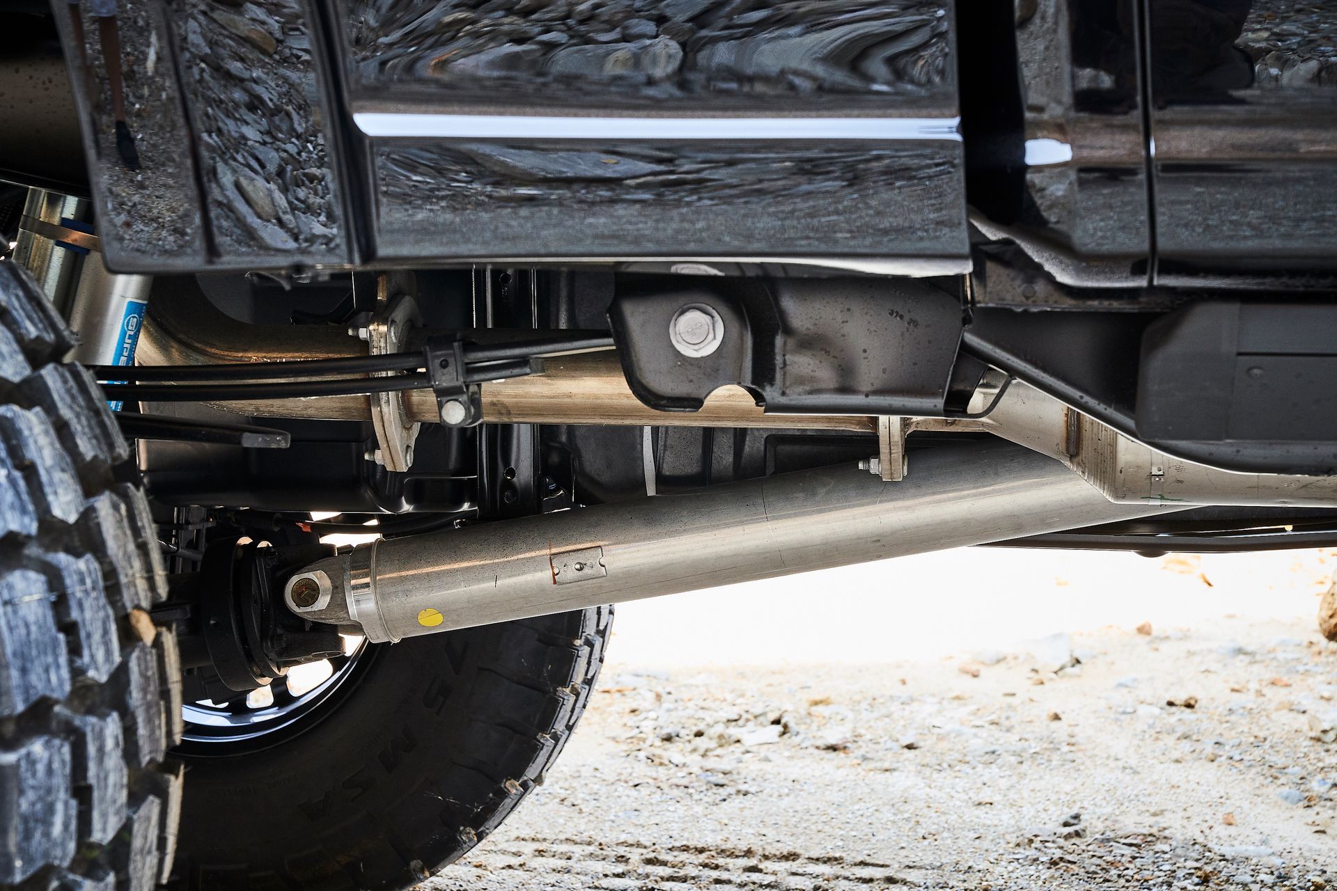 A close up of the underside of a truck 's suspension system.