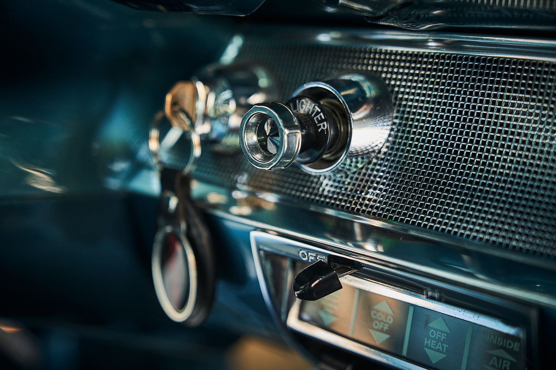 A close up of a car dashboard with a key in it.