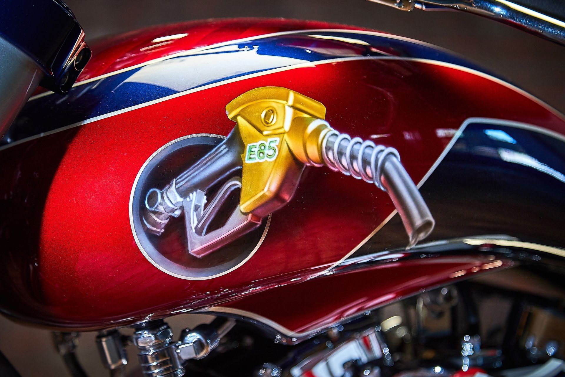 A red and blue motorcycle with a gas pump on it