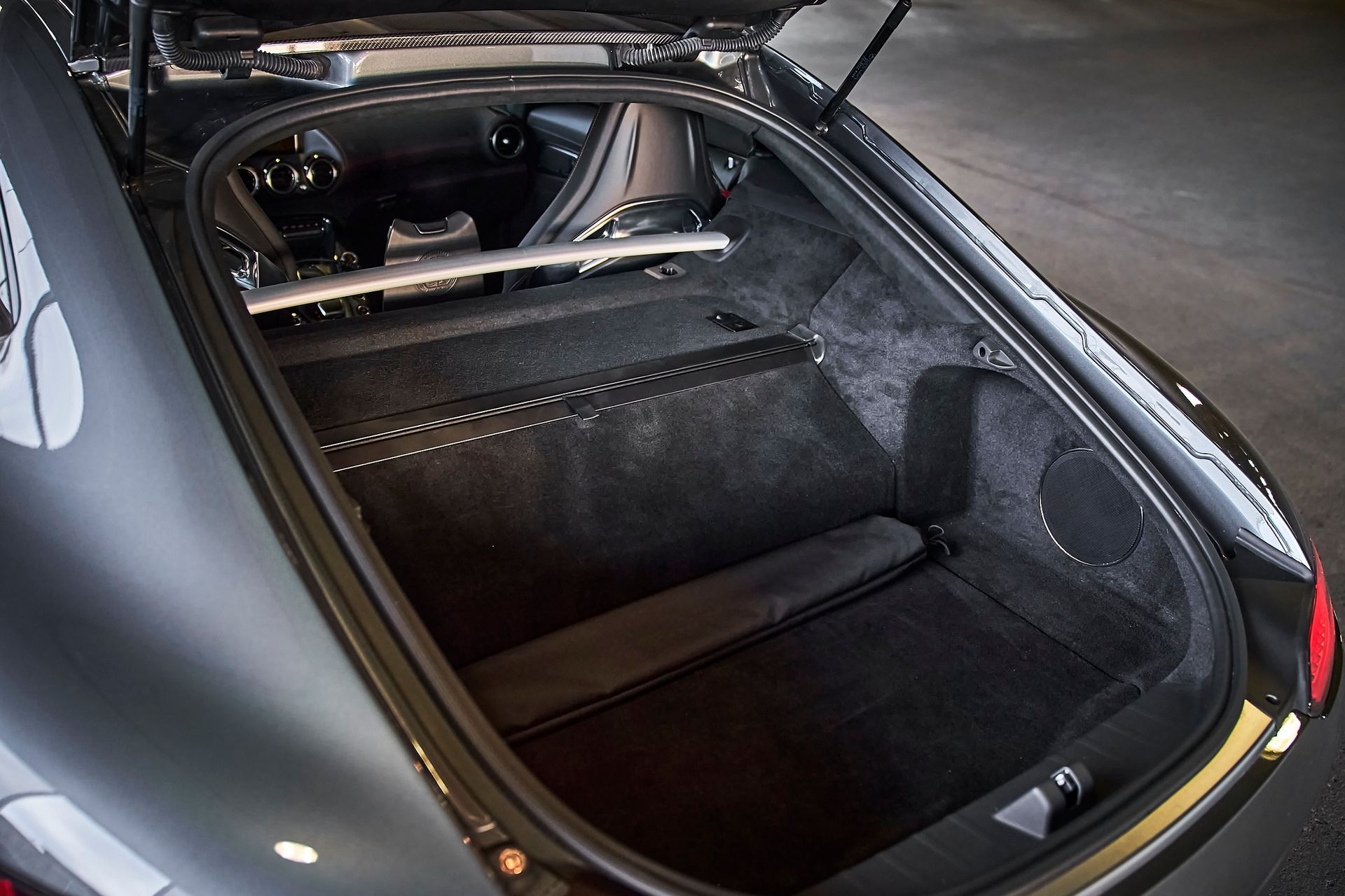 The trunk of a car is open and empty.