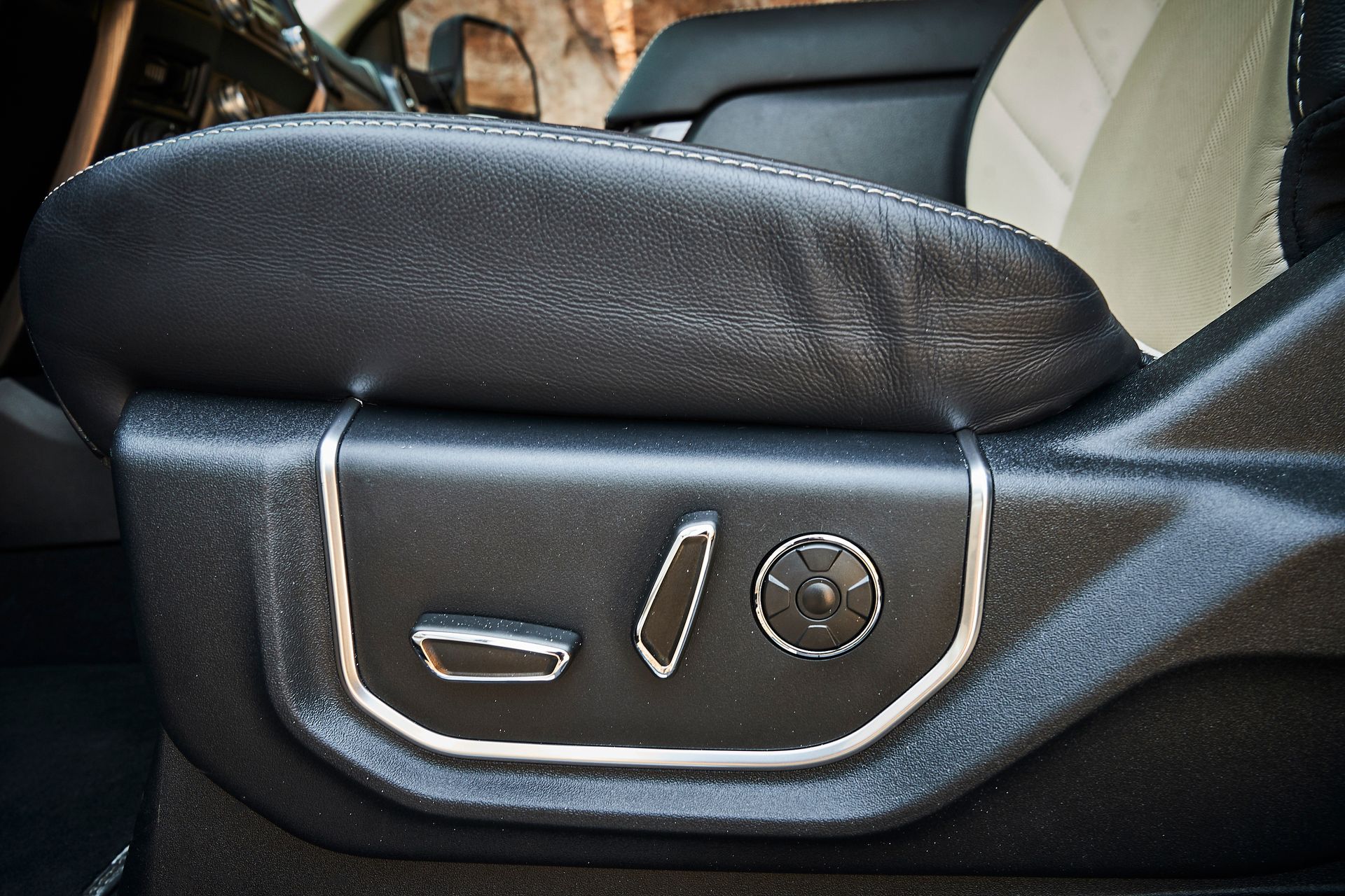 A close up of a car seat with buttons on it