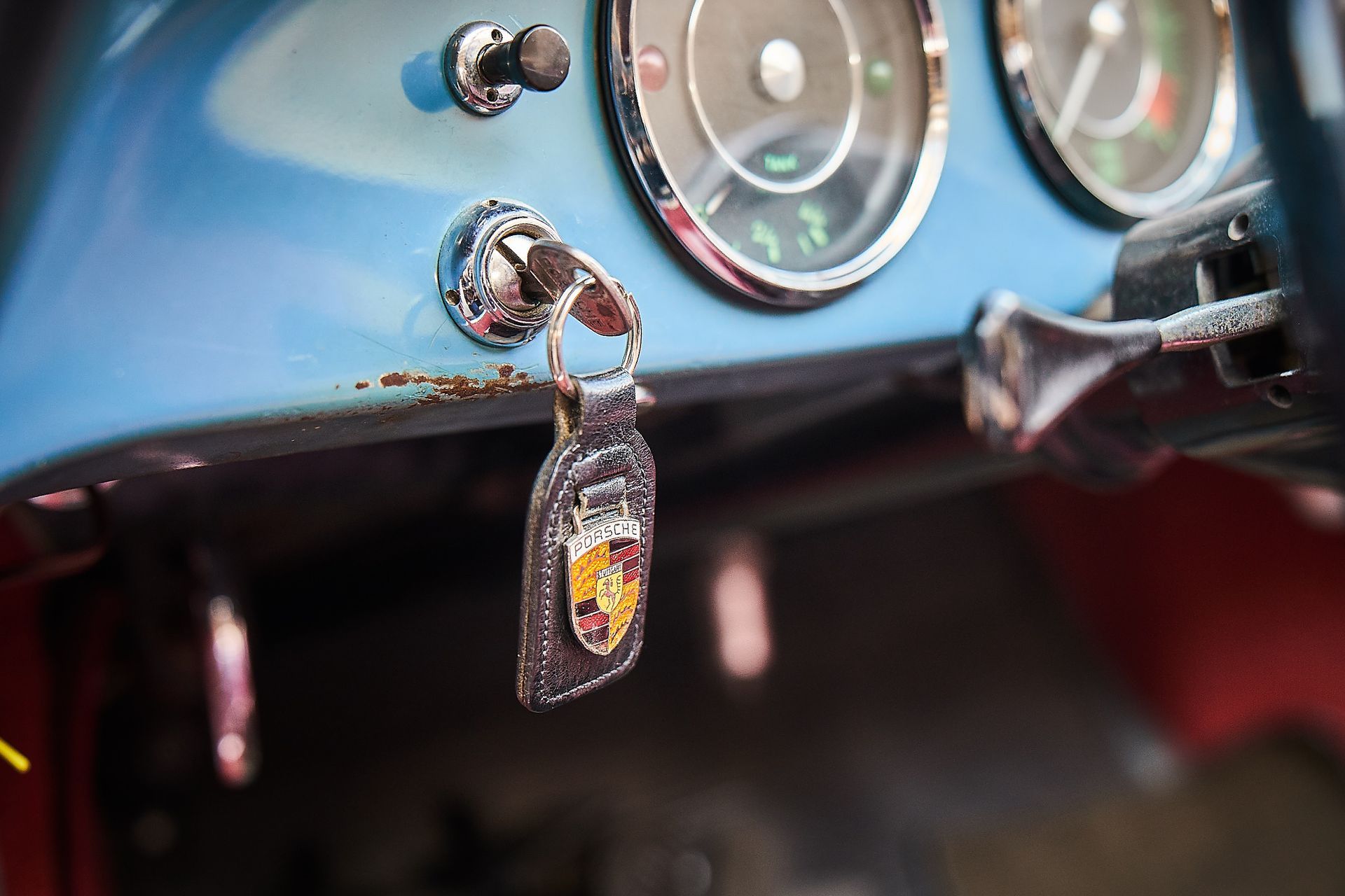 A close up of a car dashboard with a key hanging from it.