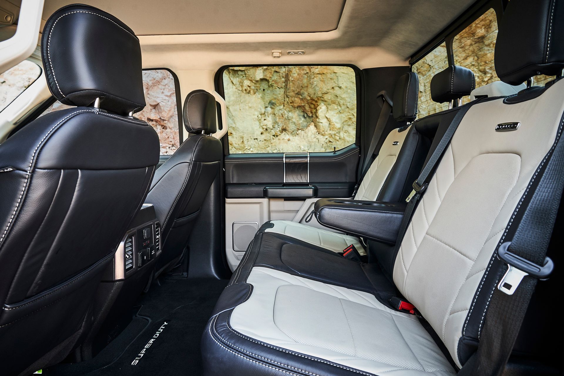 The back seats of a ford f150 truck are black and white.