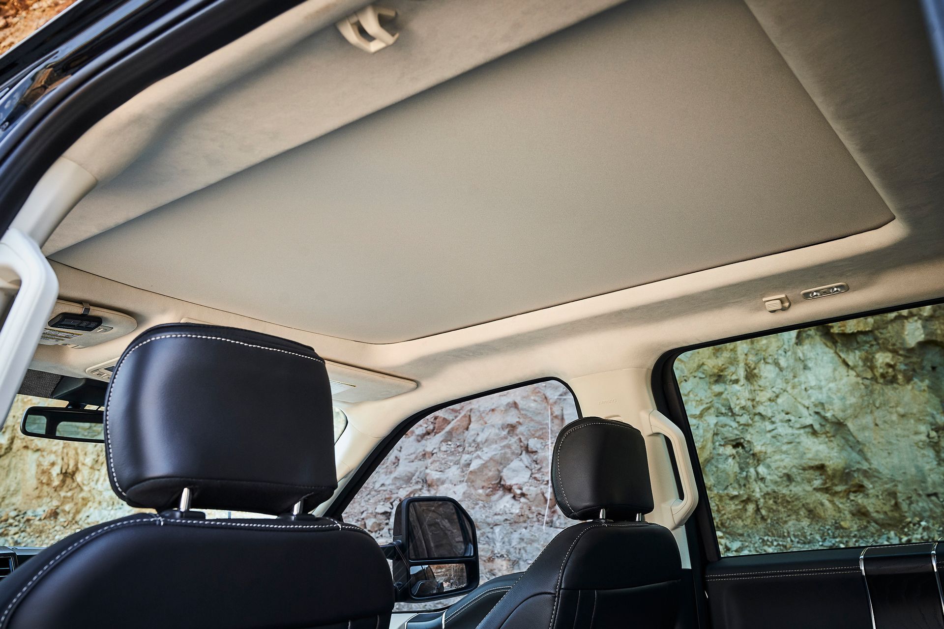 The roof of a car with a sunroof and headrests