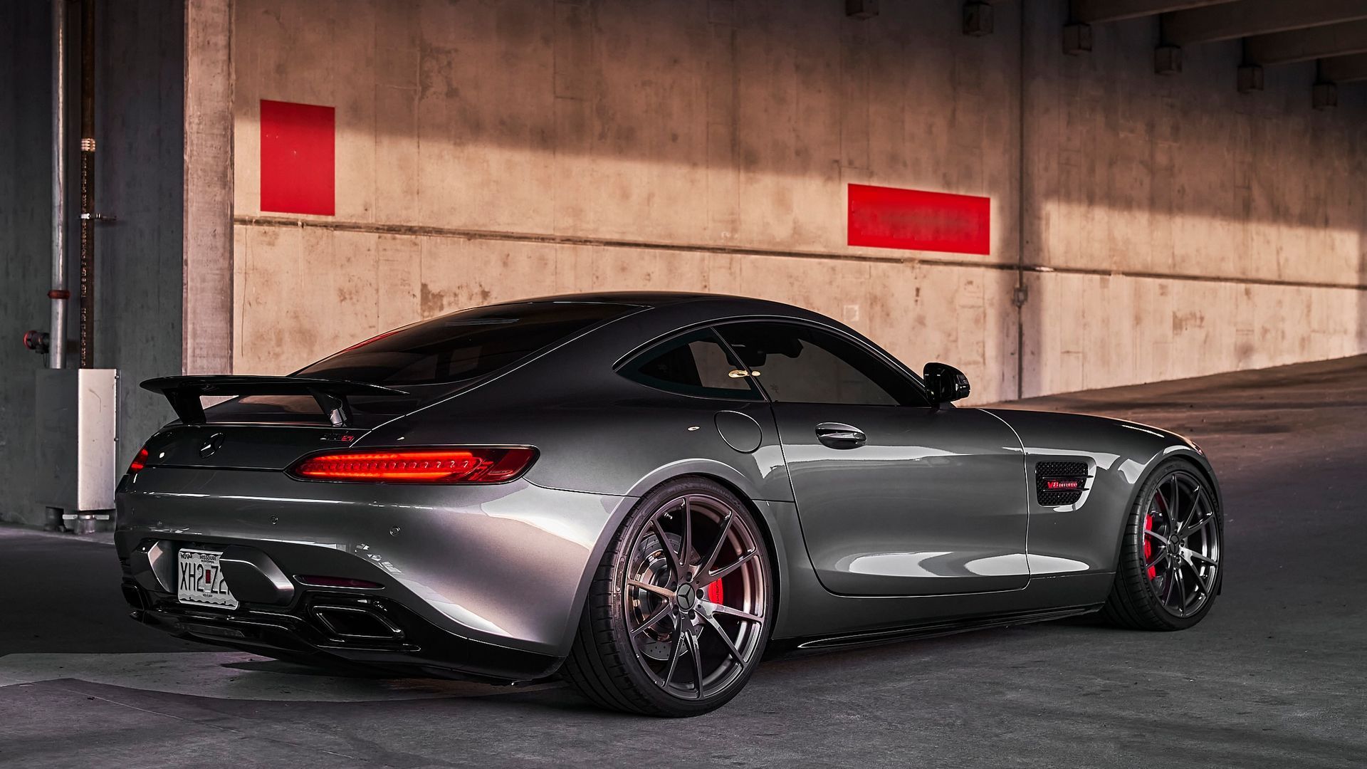 A mercedes amg gt is parked in a parking garage.