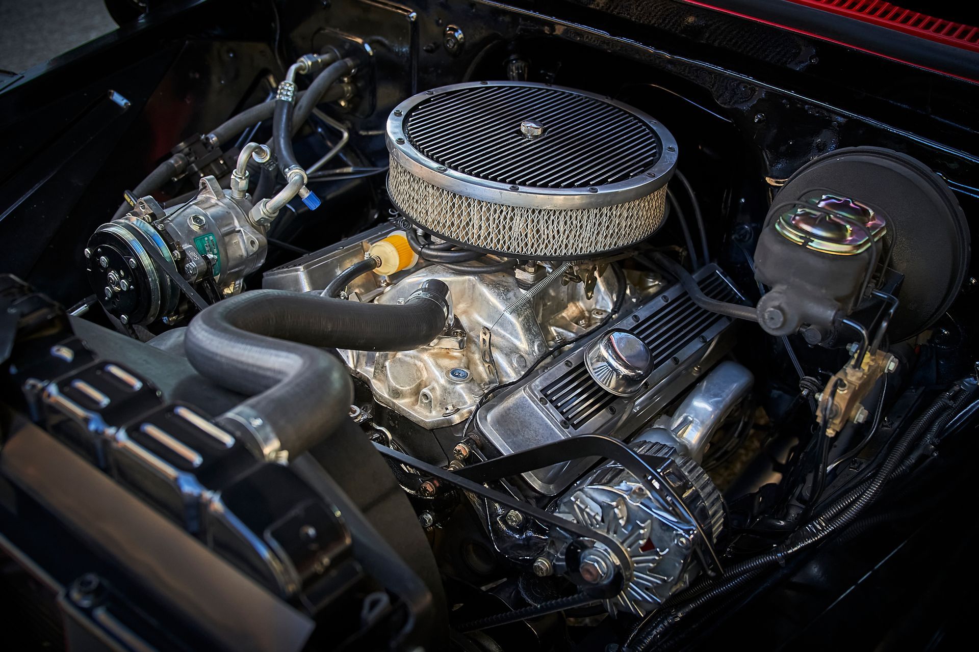 A close up of a car engine with a air filter