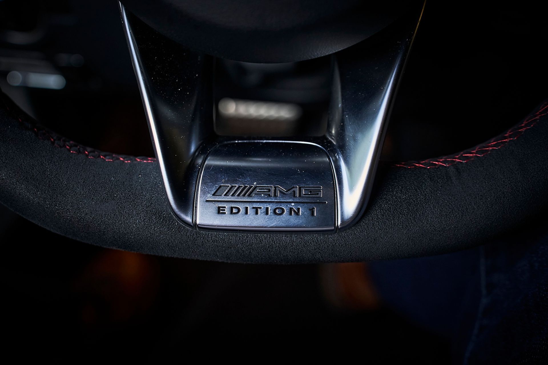 A close up of a mercedes amg edition 1 steering wheel.