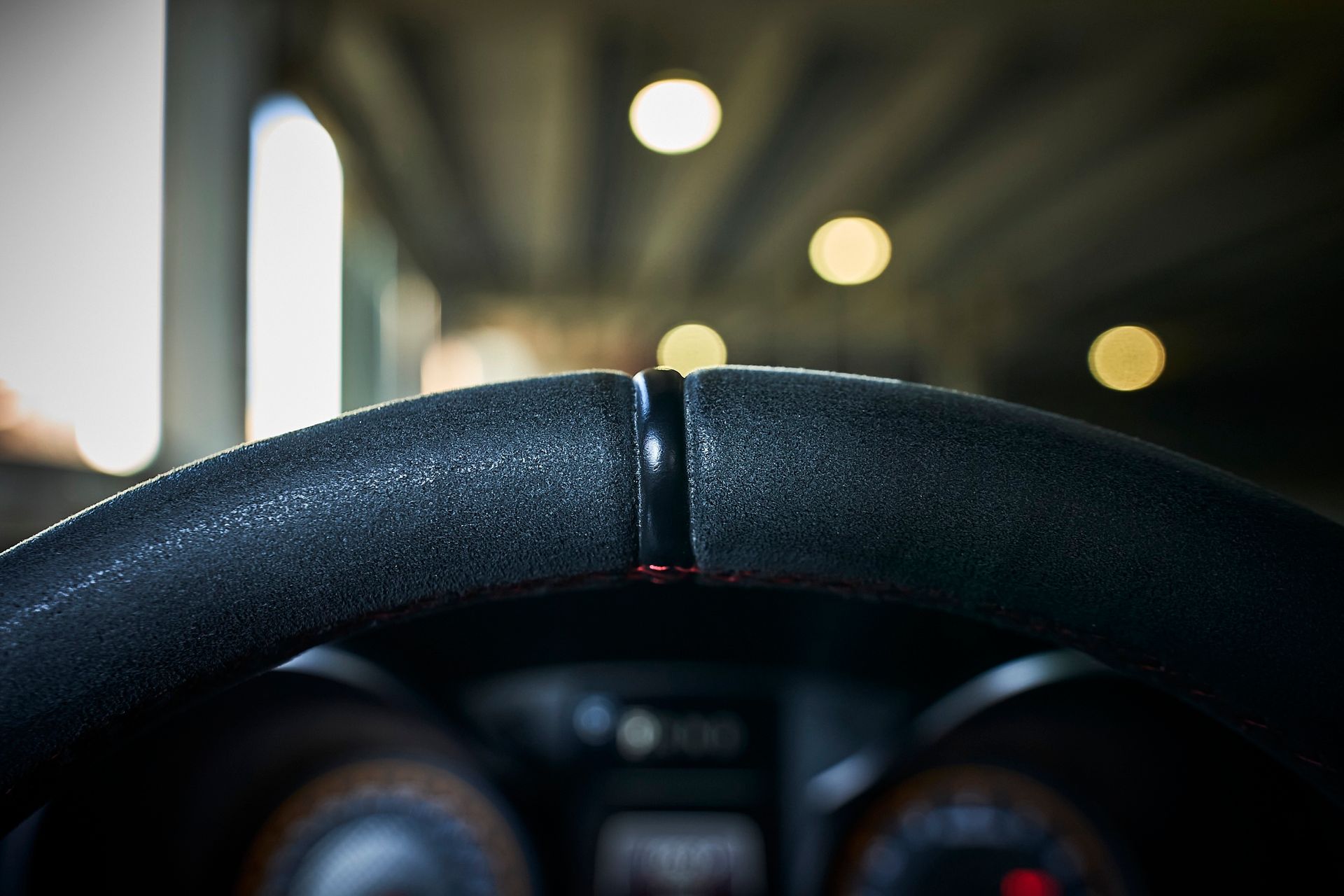 A close up of a car steering wheel in a tunnel.