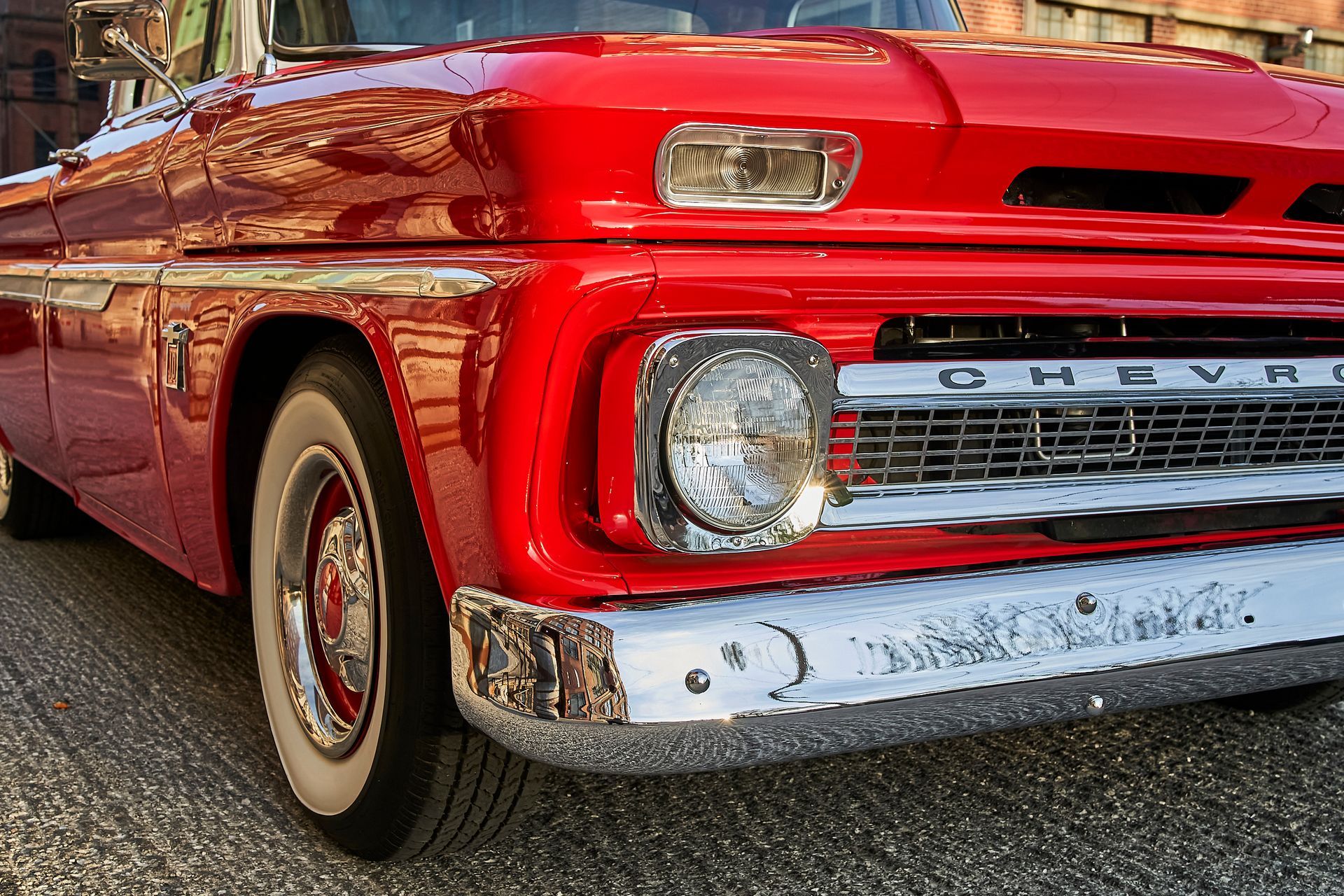 A red chevrolet truck is parked on the side of the road