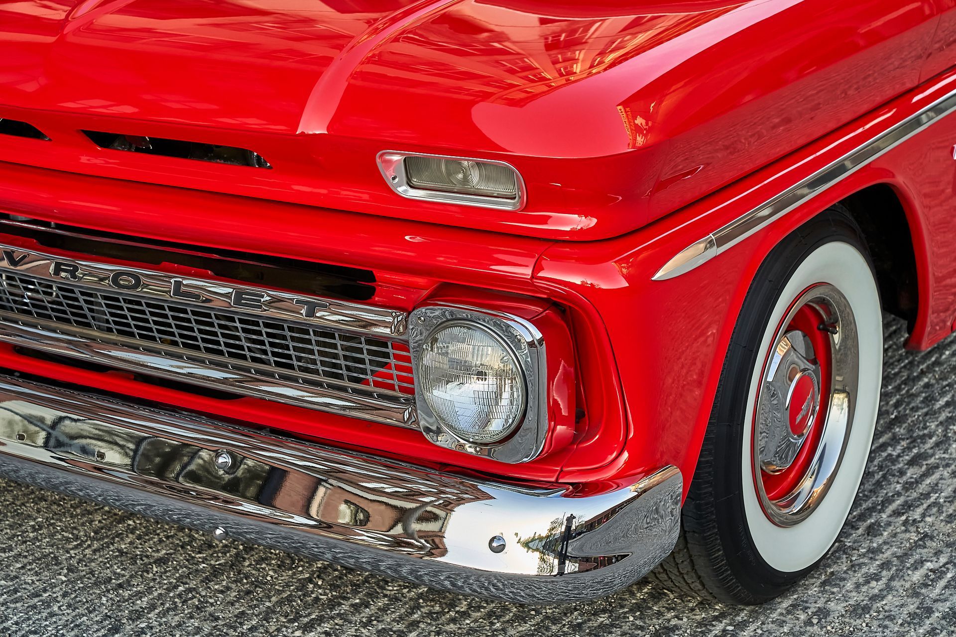 A close up of a red truck with white tires