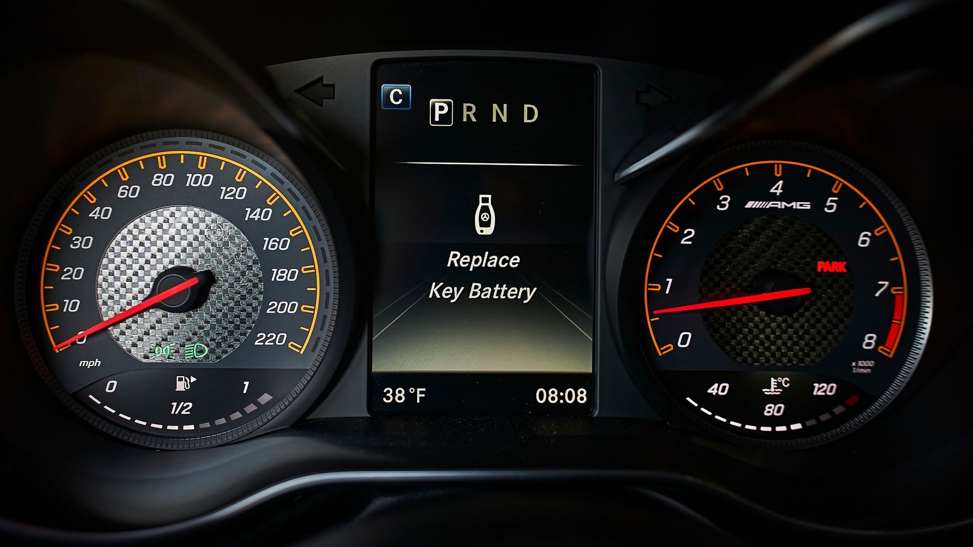 A close up of a car dashboard with a screen that says reduce key battery