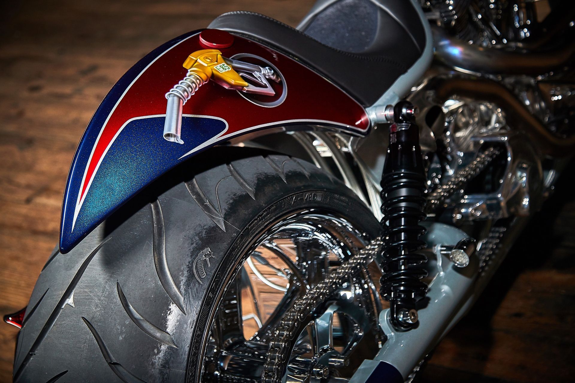 A close up of a motorcycle with a red and blue fender