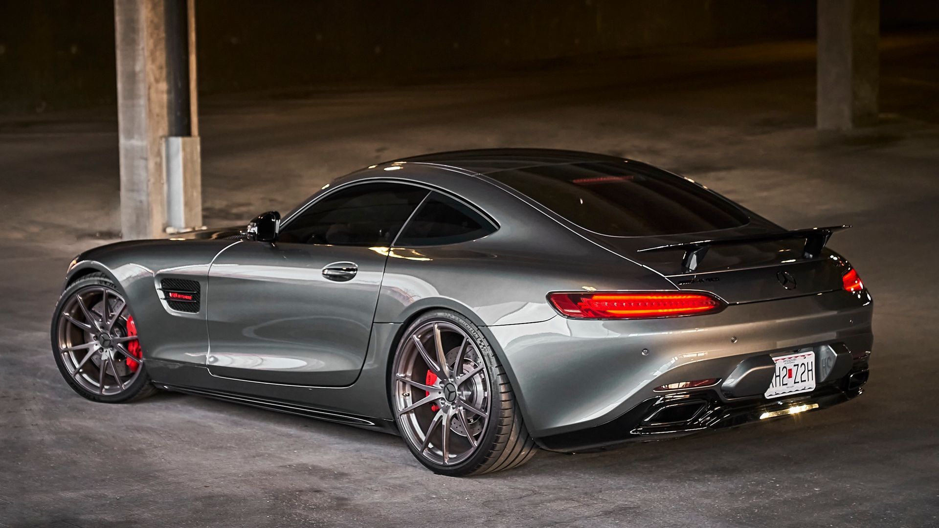 A mercedes amg gt is parked in a parking garage.