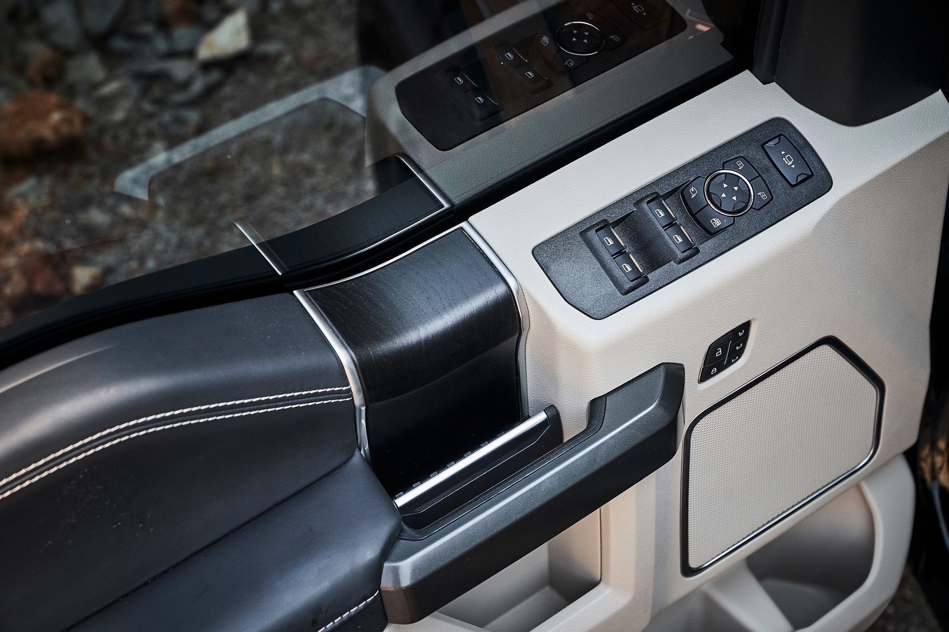 A close up of a car door with buttons on it