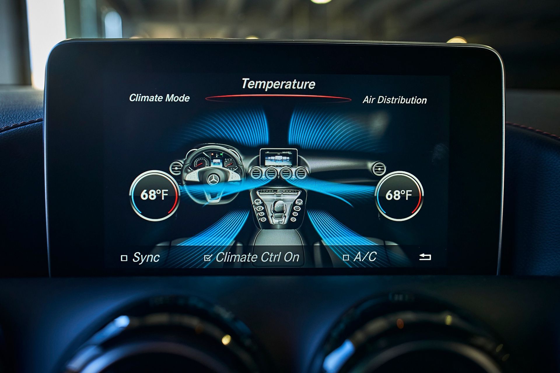 A close up of a car dashboard with a temperature displayed on the screen.