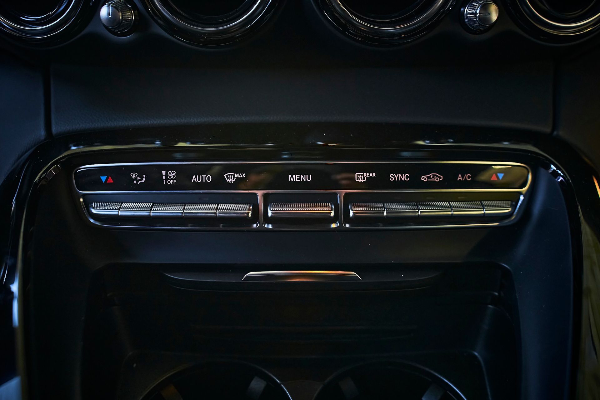 A close up of a car 's a/c control panel.