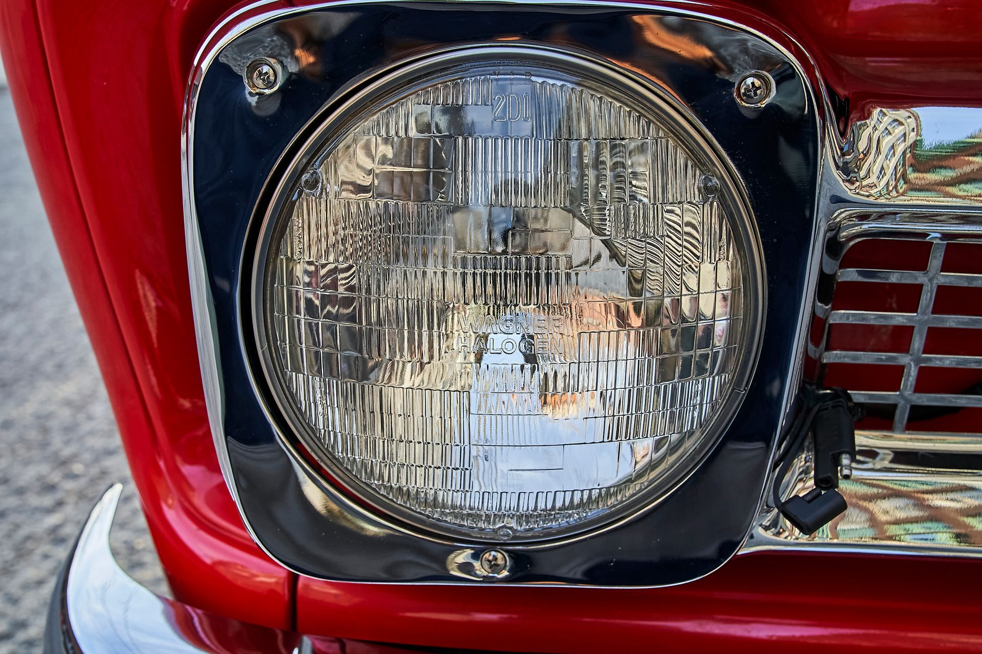 A close up of a headlight on a red car