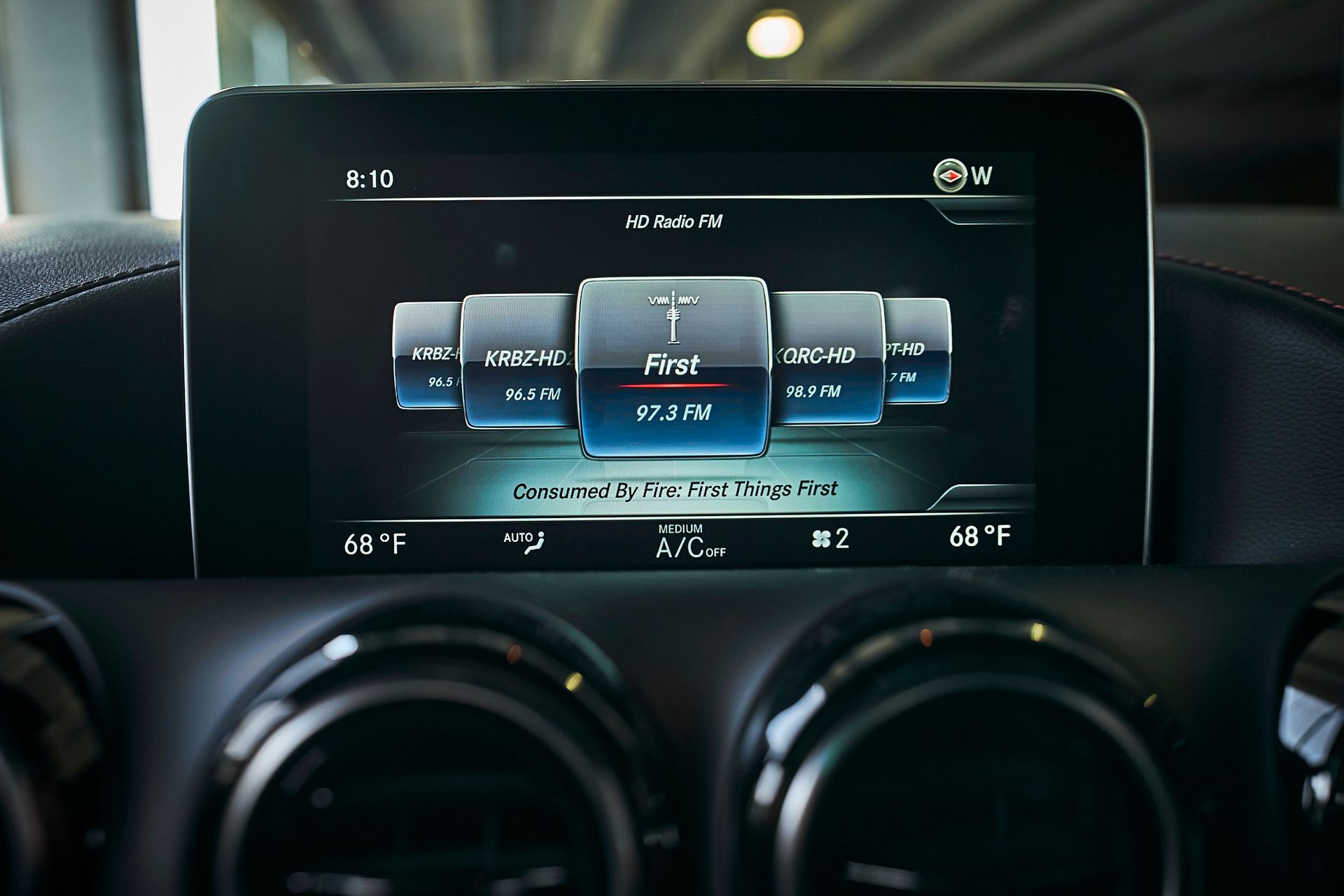 A close up of a car dashboard with a touchscreen display