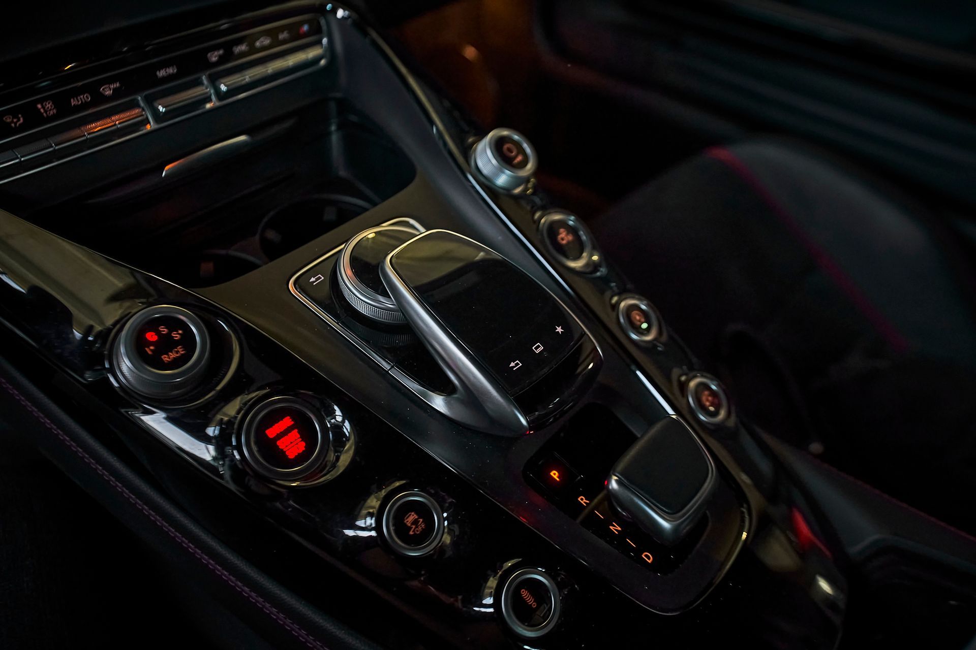 A close up of a car dashboard with a lot of buttons and controls.
