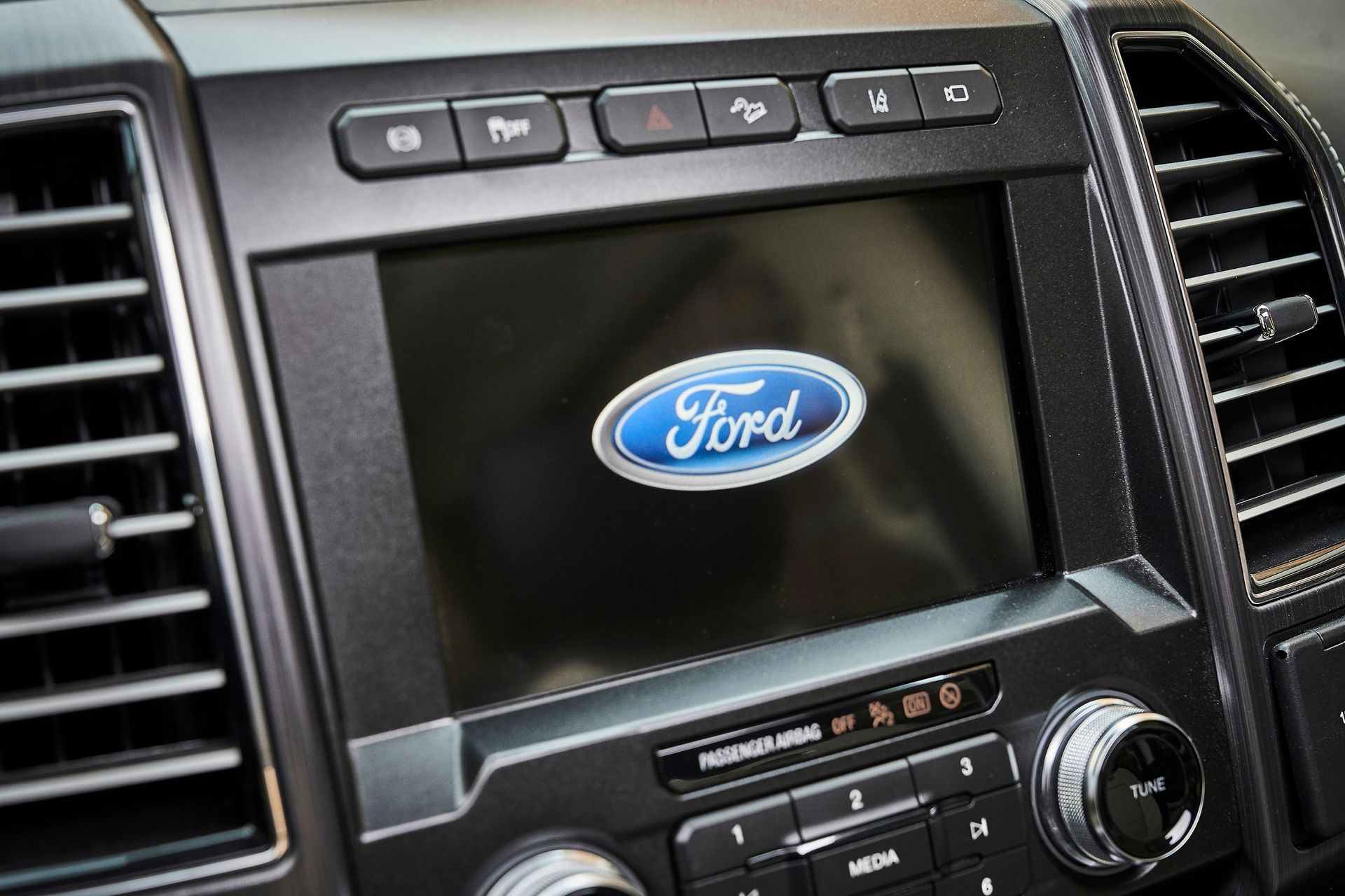 A close up of a ford radio in a car.