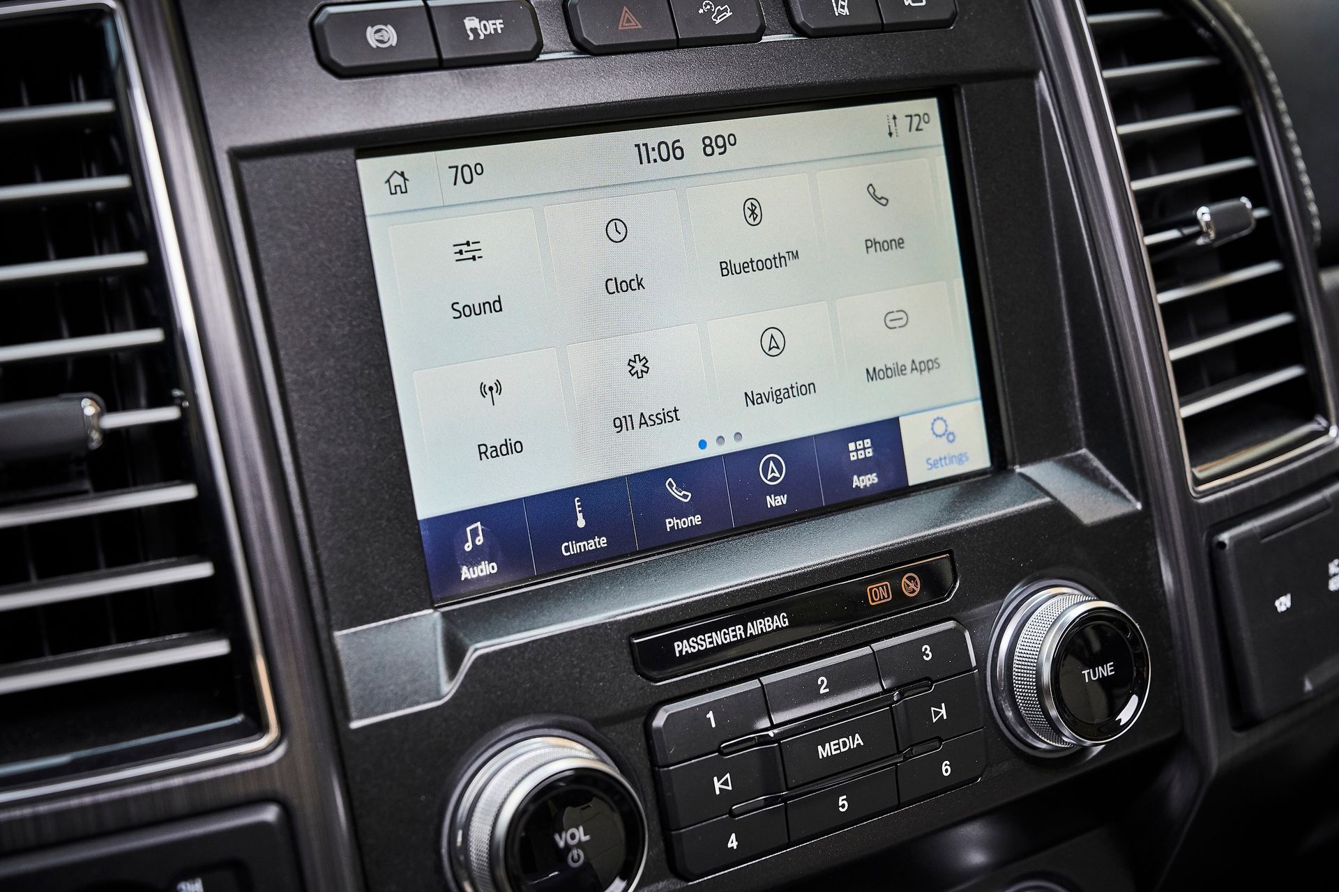 A close up of a car dashboard with a touchscreen display.
