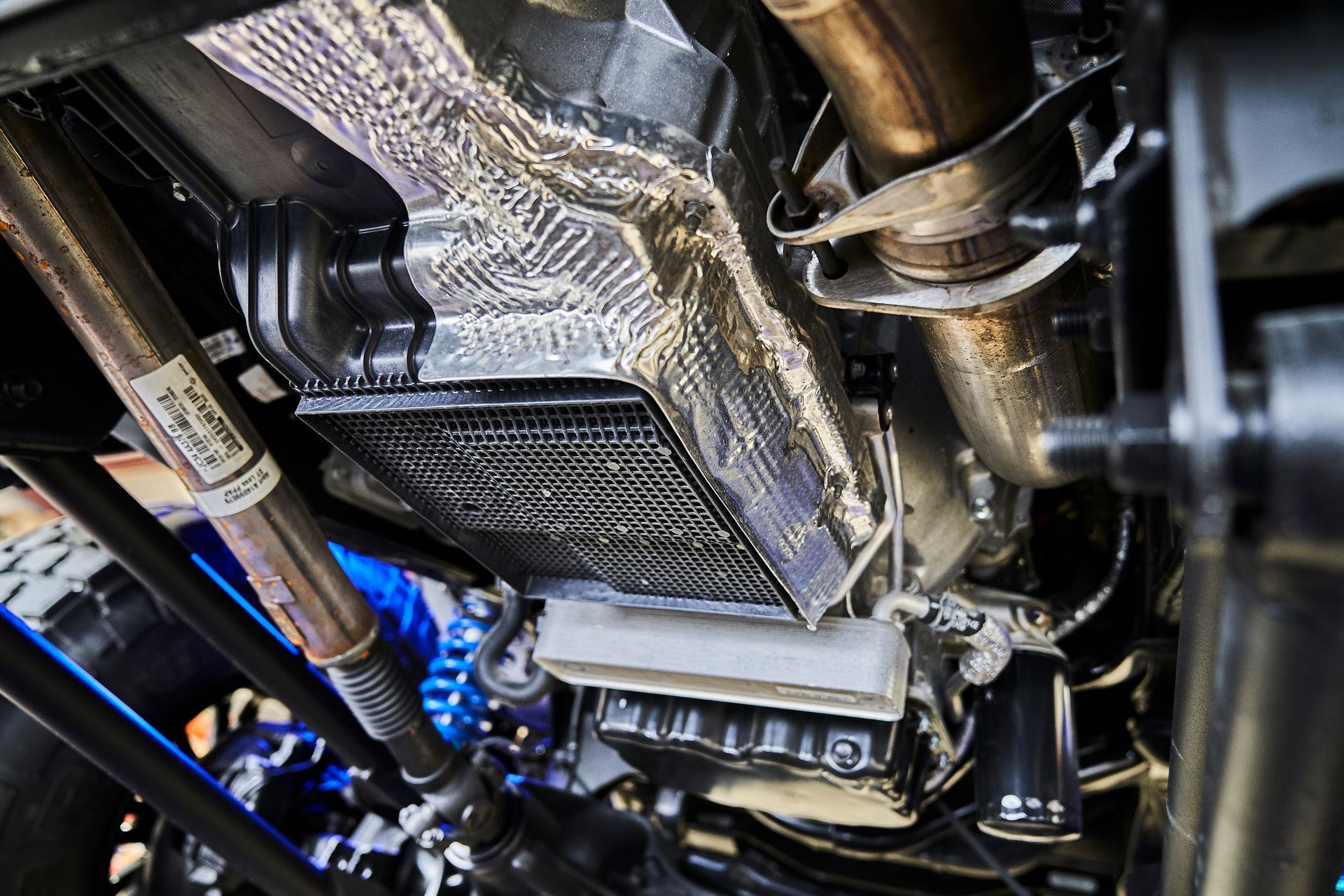 A close up of the underside of a car engine.