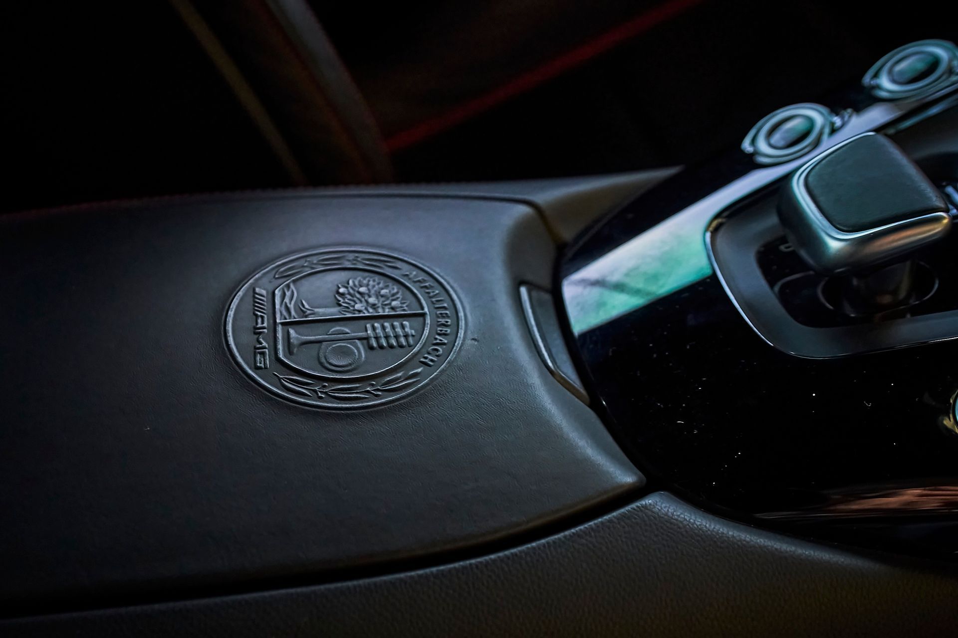 A close up of a car steering wheel with a logo on it.