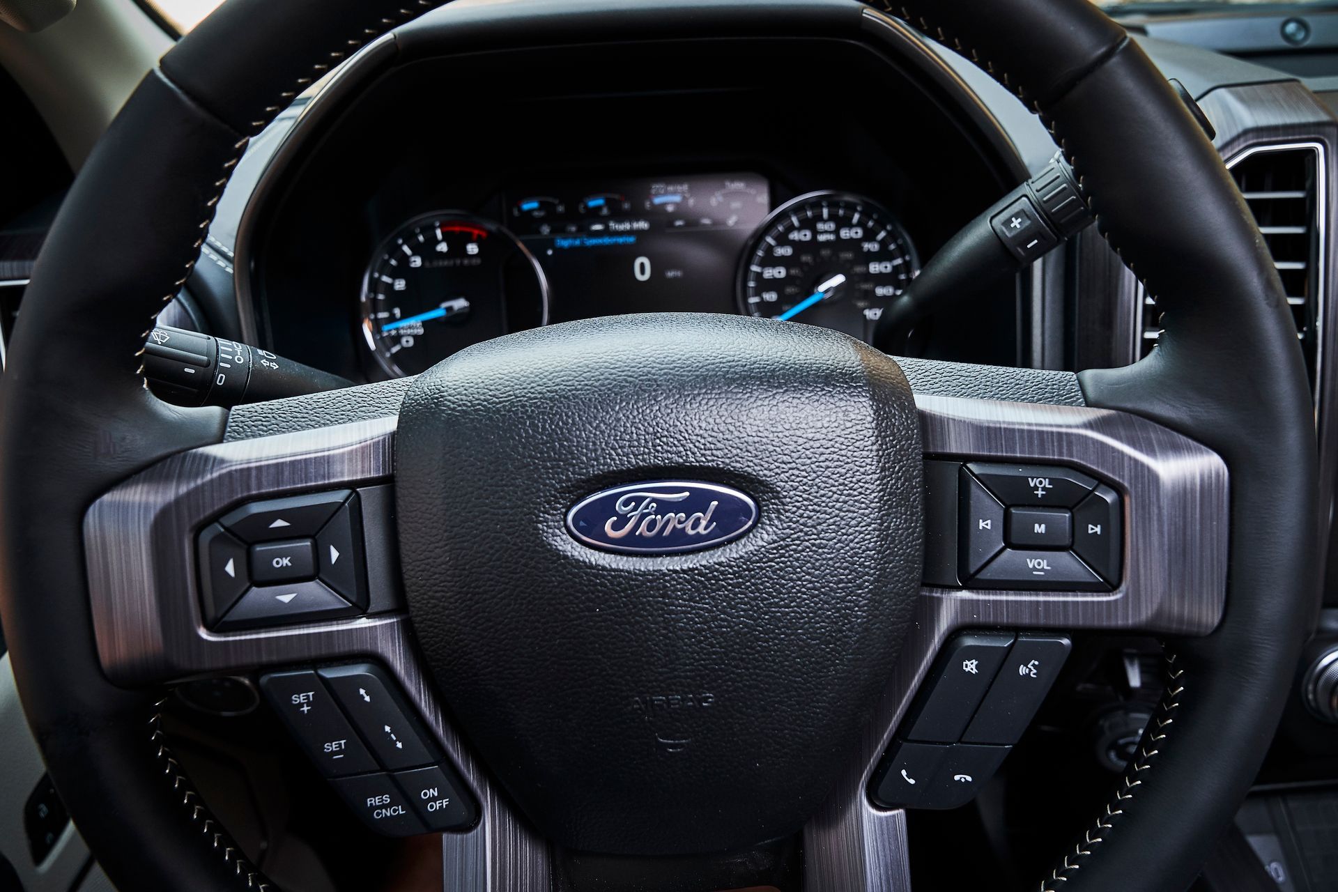 A close up of a ford steering wheel and dashboard