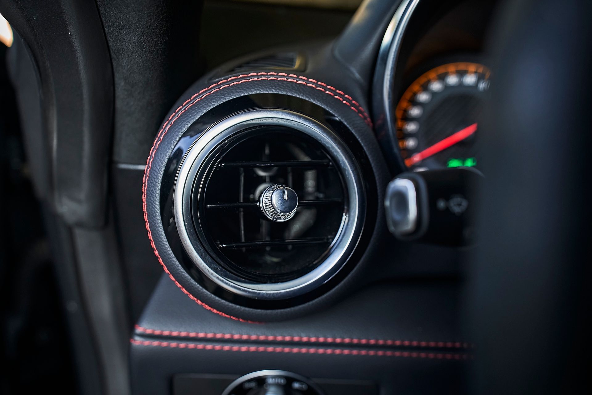 A close up of an air vent in a car.