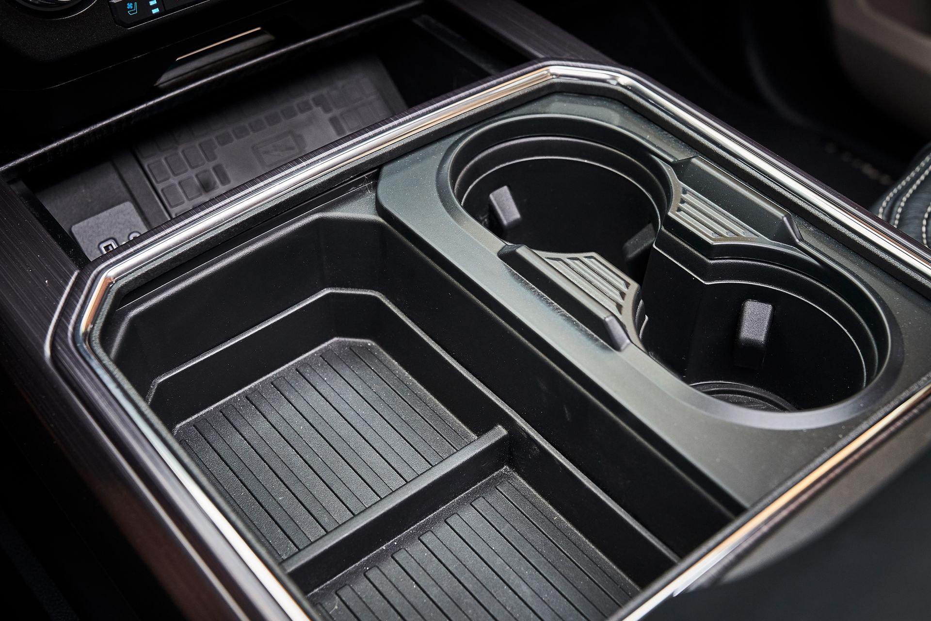 A close up of a cup holder in a car.
