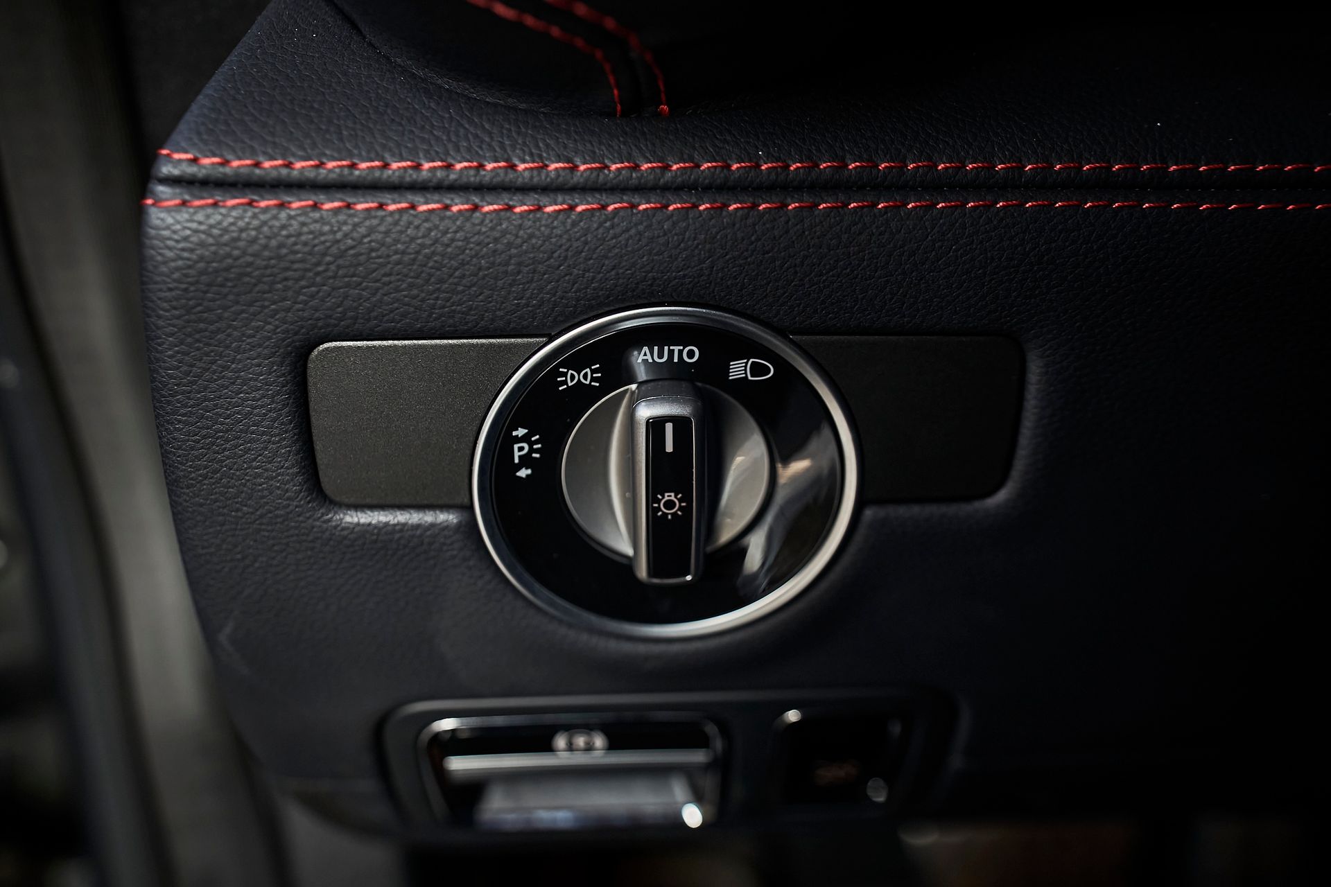 A close up of a light switch on the side of a car.