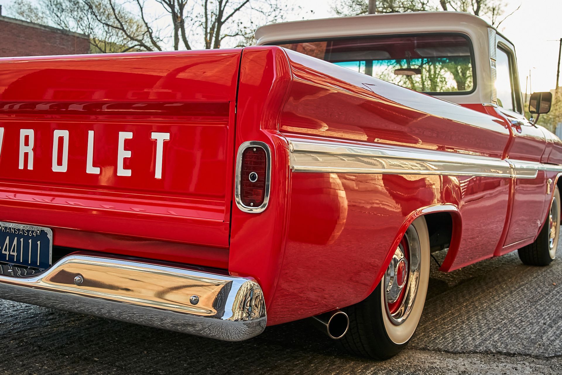 A red chevrolet truck is parked on the side of the road