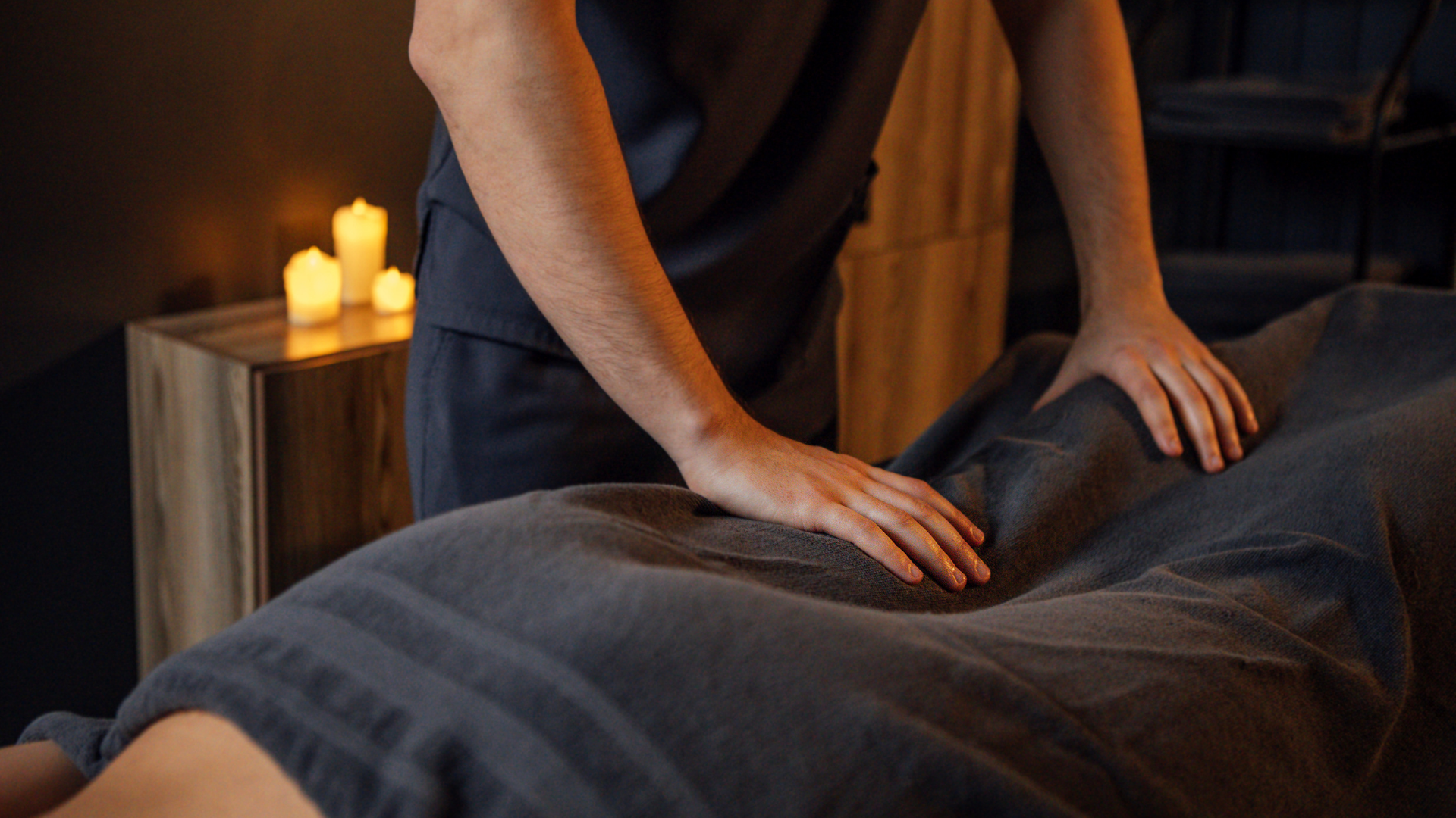 Massage therapist performing deep tissue massage on a client's back
