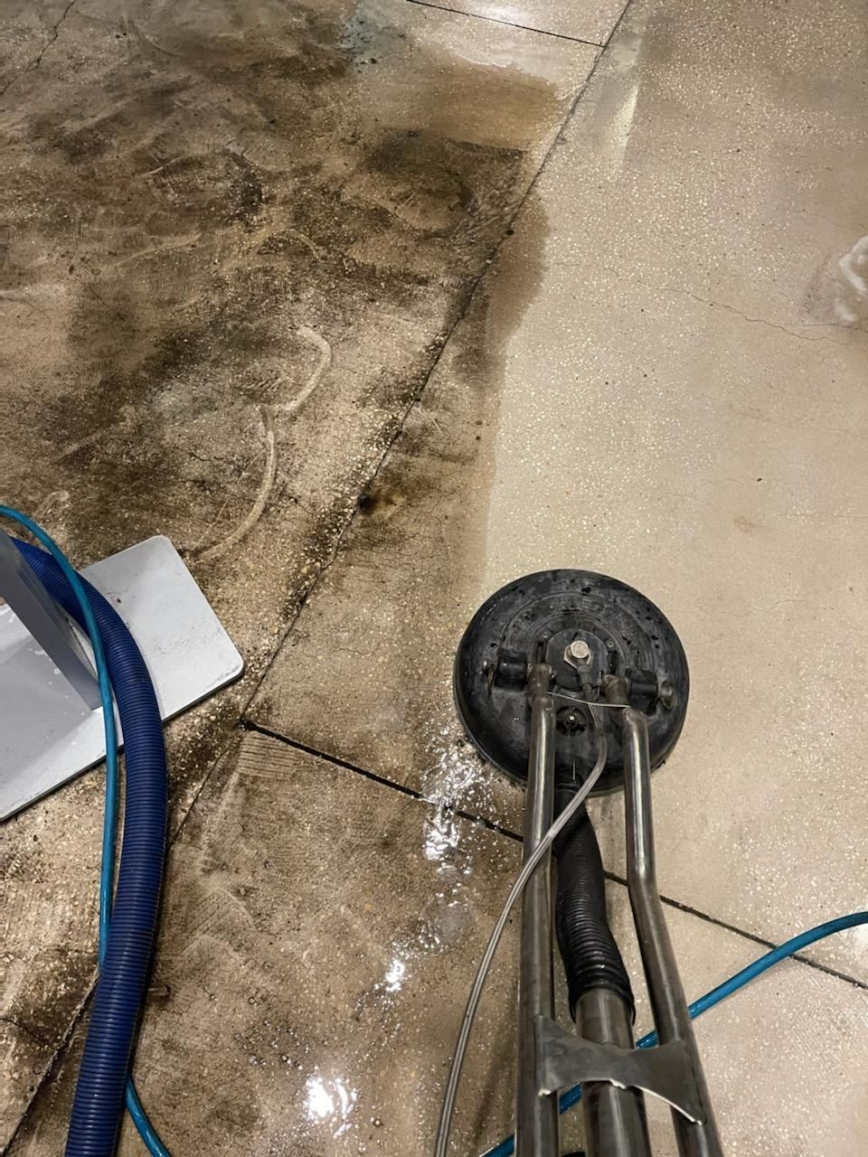 Floor polishing machine cleaning a patterned marble floor.