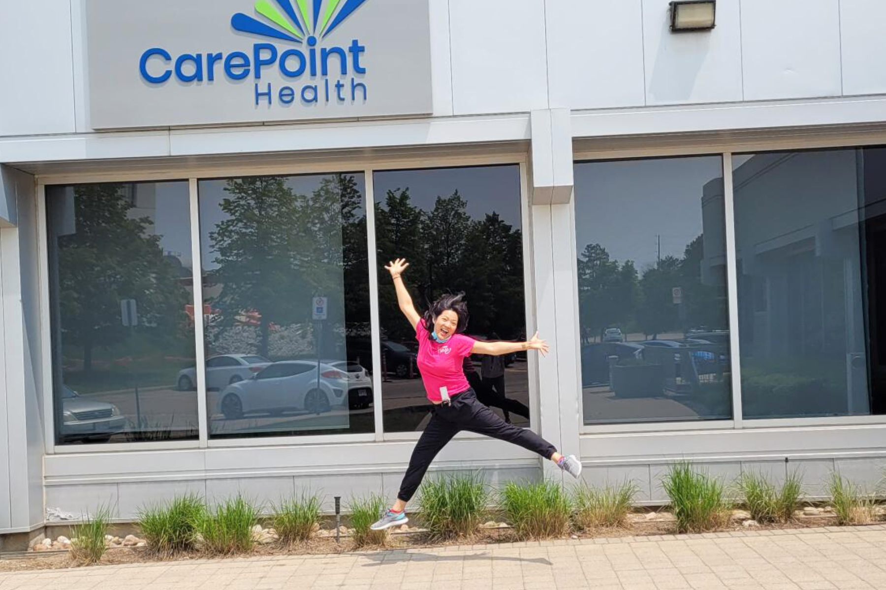 Two women are standing in front of a carepoint health booth.