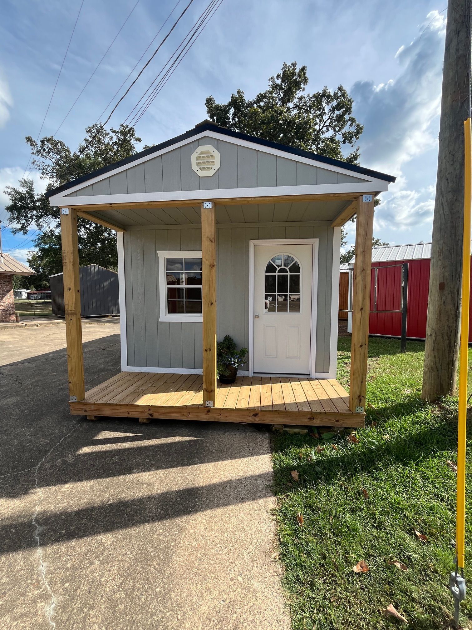 A picture of a wooden house with a porch