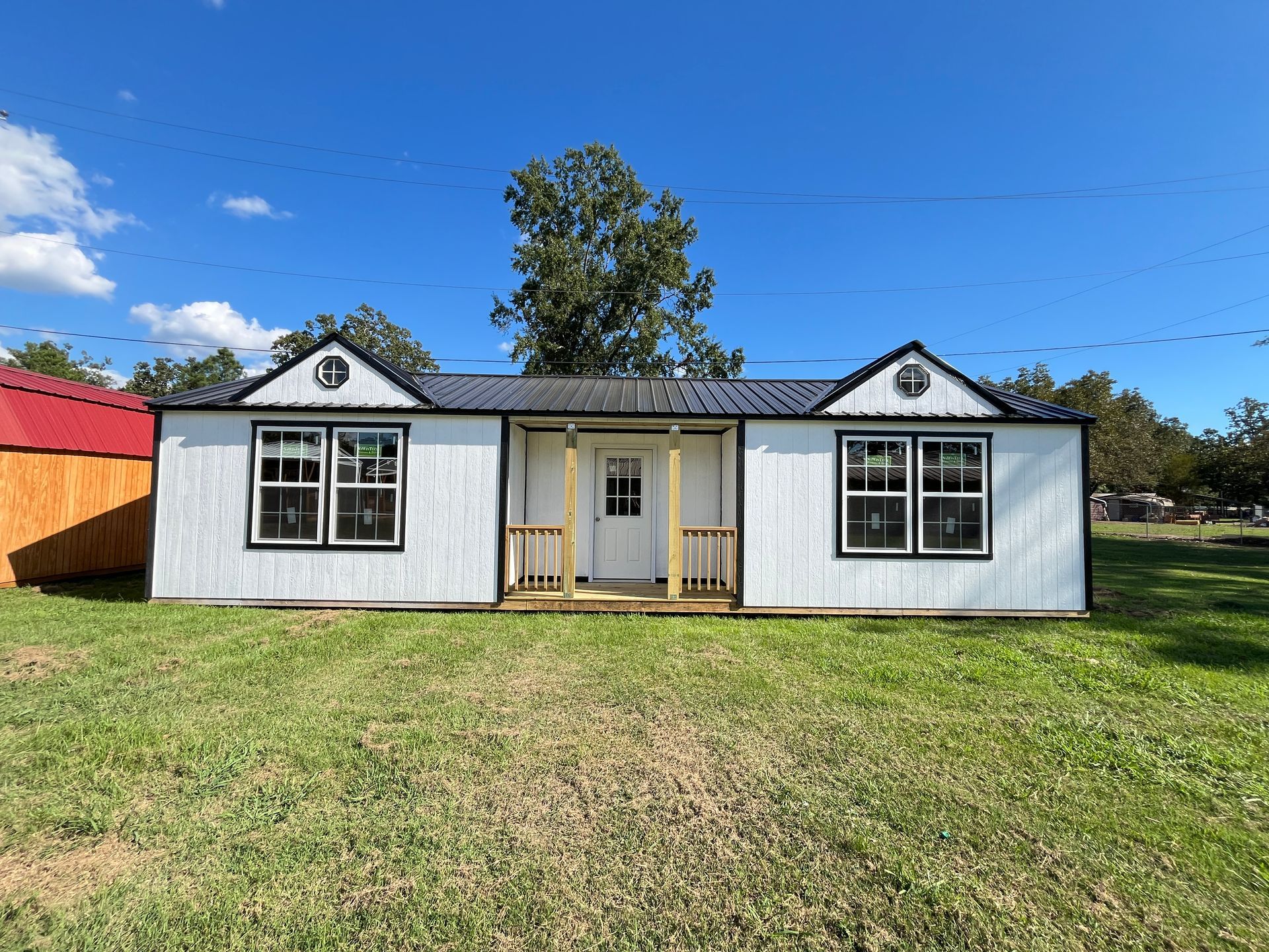 A picture of a wooden house with a porch