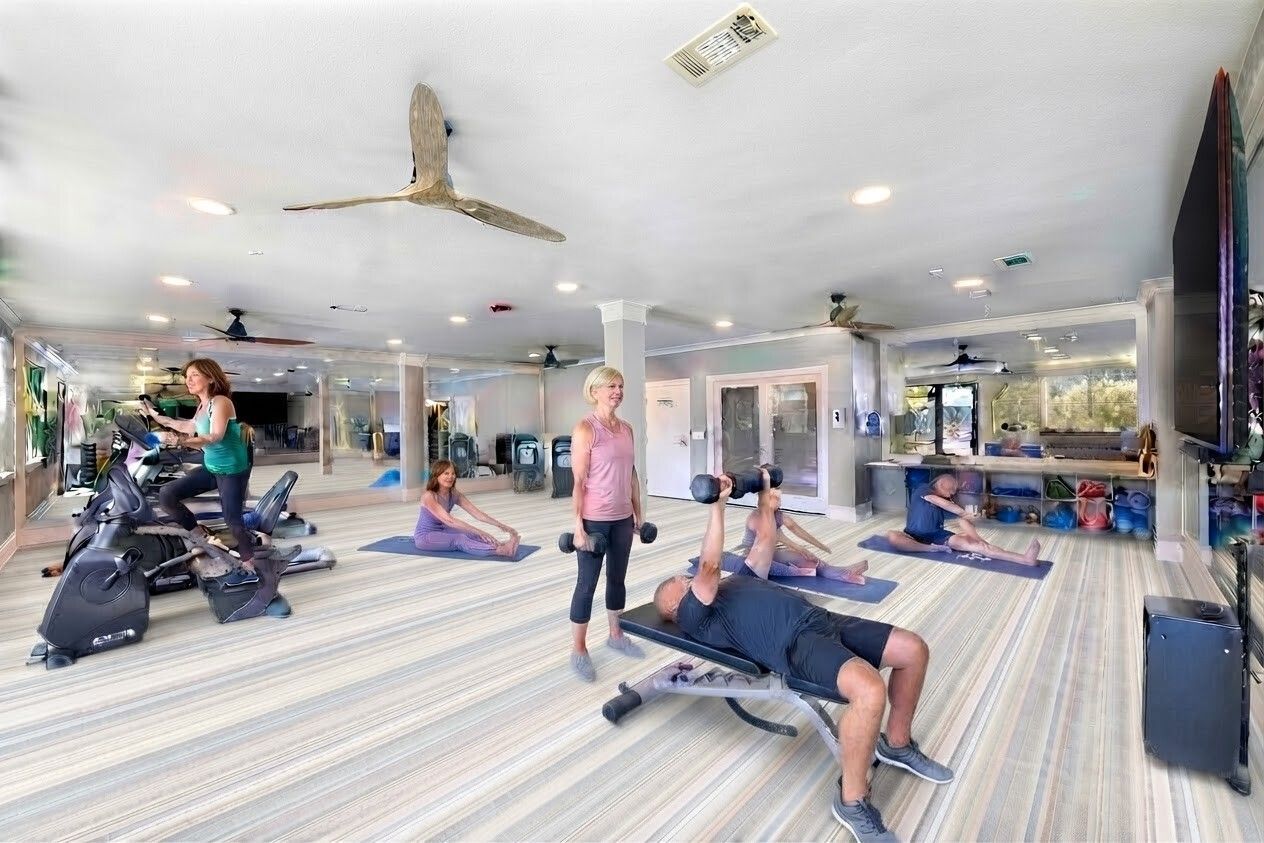 People exercising in a bright studio with striped floor, mirrors, and ceiling fans