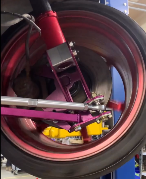 A close up of a purple wheel on a car