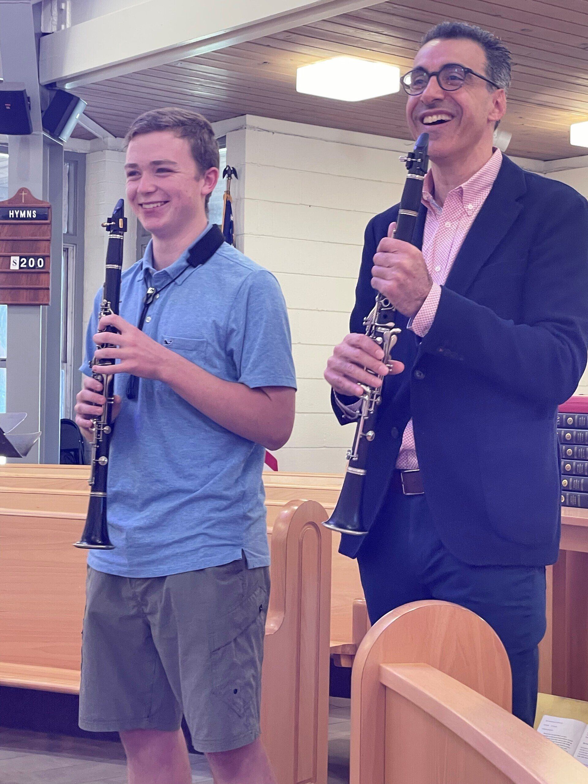 Oskar Espina-Ruiz and student smiling with clarinets