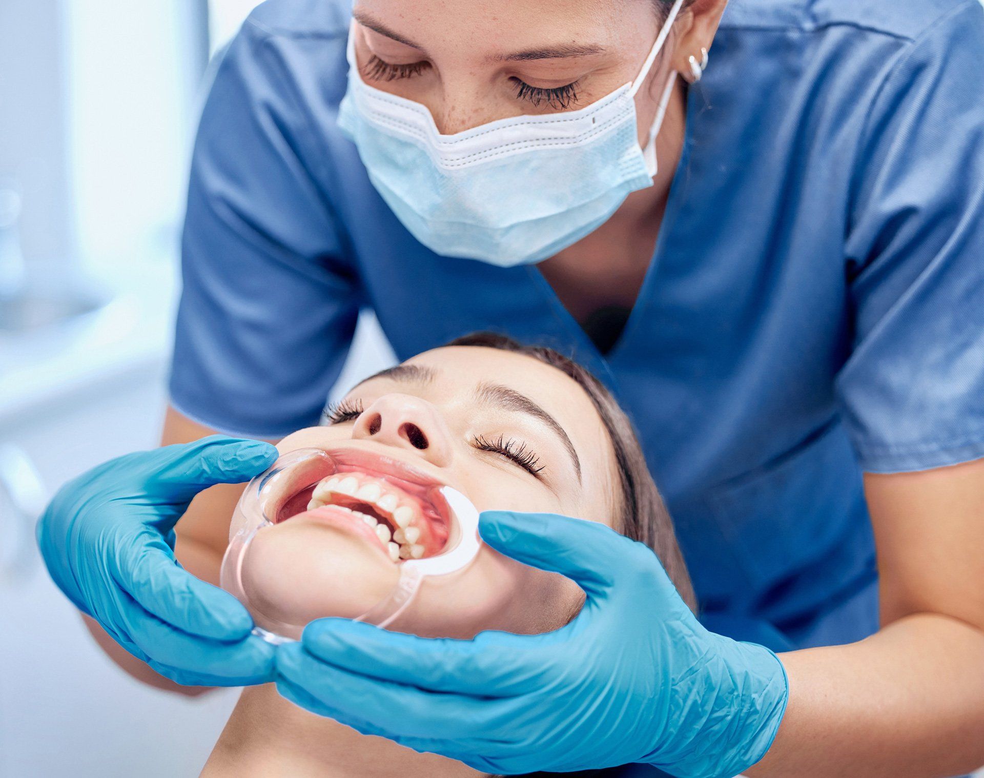 A woman wearing a mouth prop of a dentist – Blacktown, NSW – Smiles for All