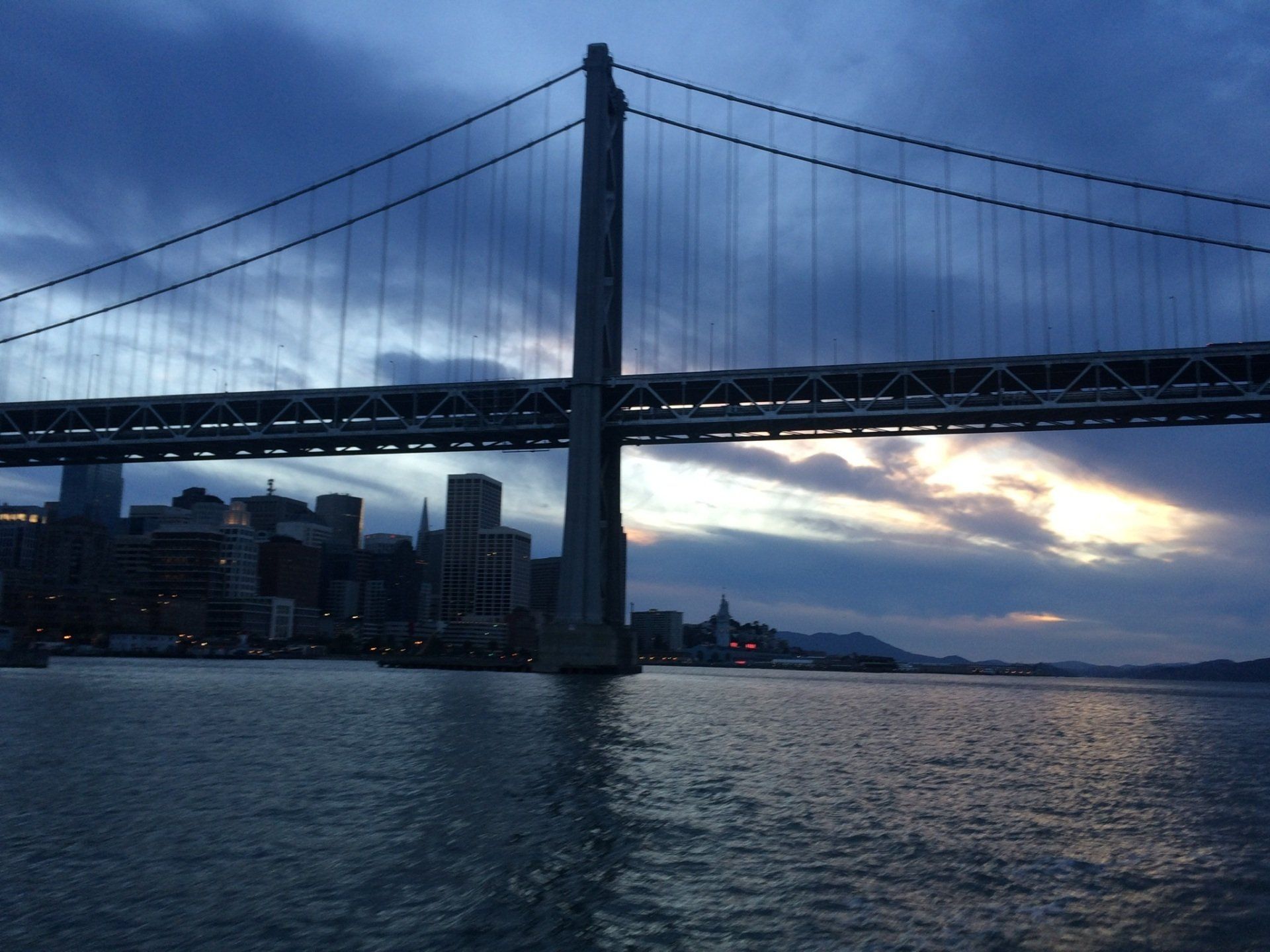 The Bay Bridge at dusk with San Francisco in the background.