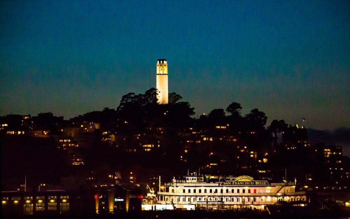 Coit Tower lit up during an evening sail.