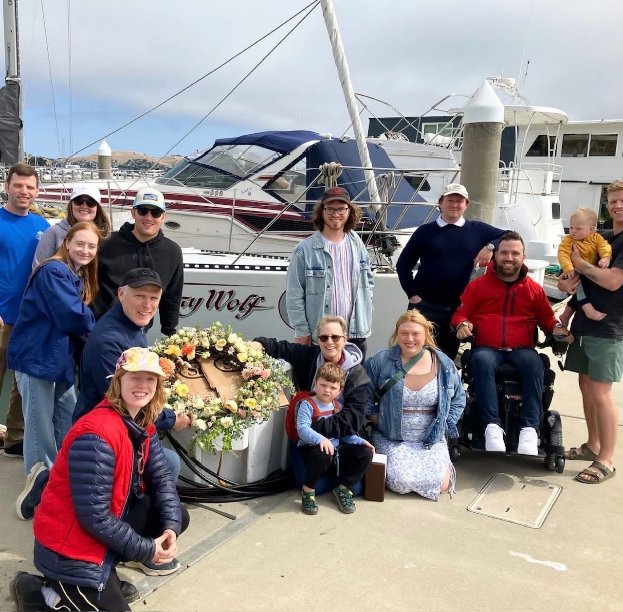 Guests on the dock with memorial flowers before an ash scattering sail with Neptunes Memorials.