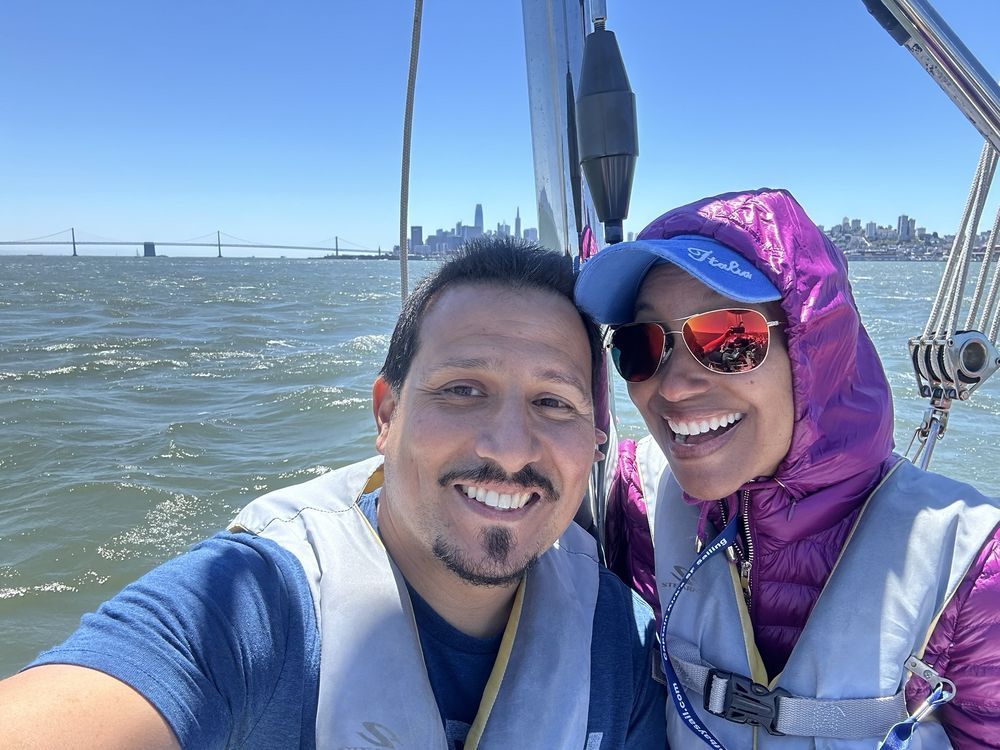 A couple enjoying a beautiful day of sailing on San Francisco Bay.